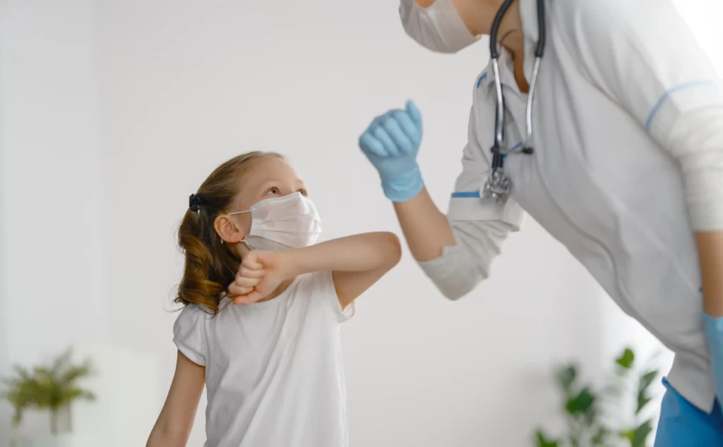 Healthcare Doctor and Child Patient Wearing Masks in Hospital