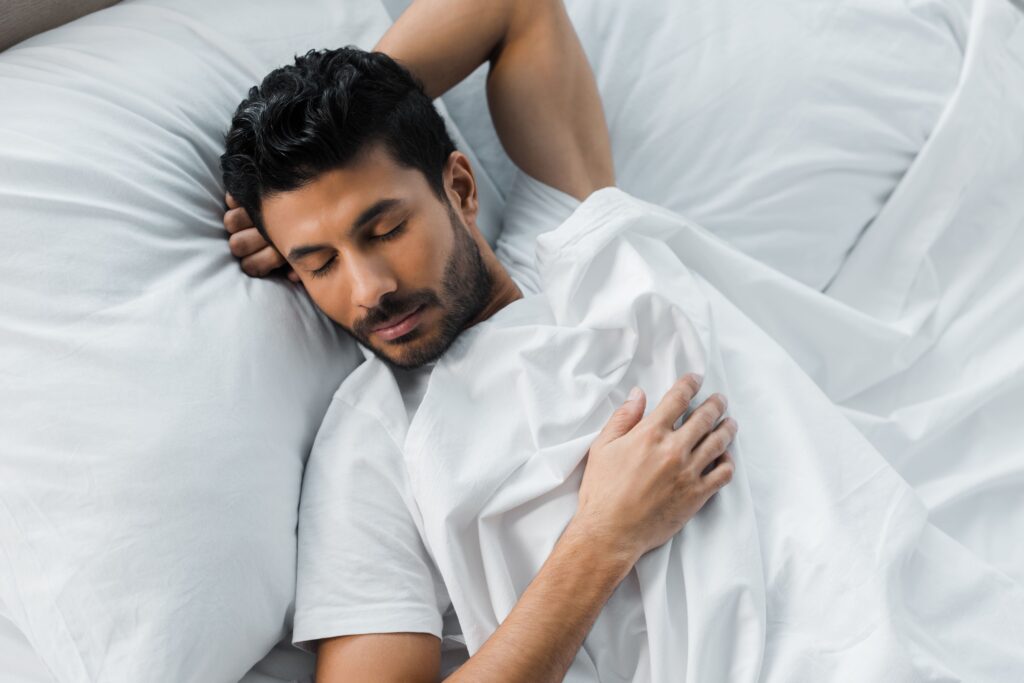 man getting great sleep after COVID 19 sickness in bed