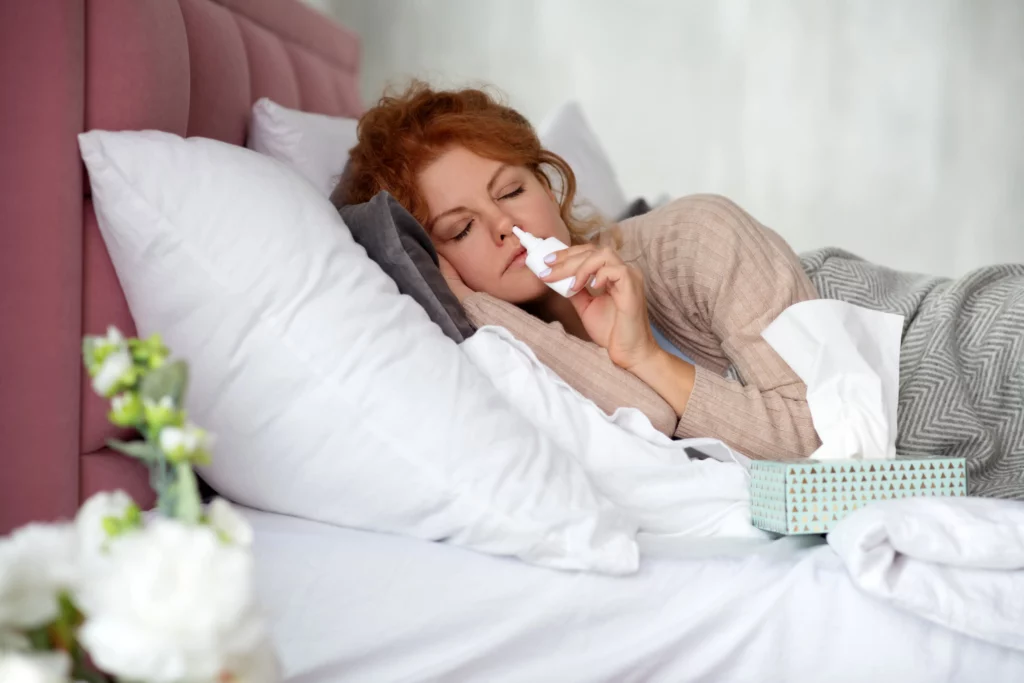 woman lying in bed with napkins and nasal spray 2021 09 03 20 25 57 utc min