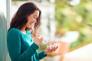Woman eating probiotic yogurt